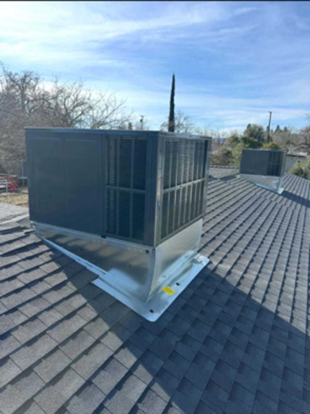 Package HVAC unit set on a new roof curb in Anderson, California