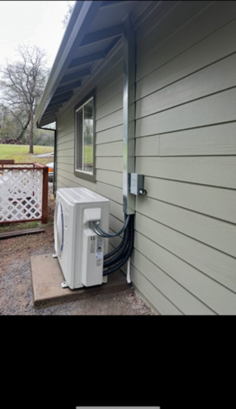 Mini-split heat pump installed along the side yard of a Palo Cedro CA home